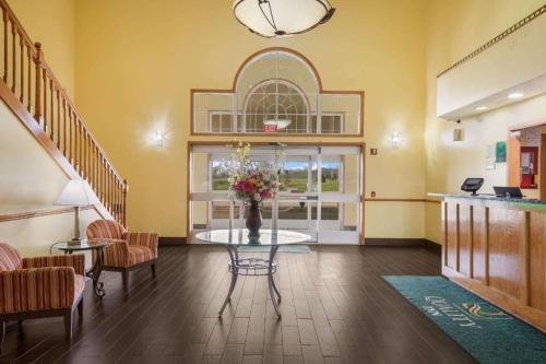 a room with a table with a vase of flowers on it at Quality Inn in Edgerton