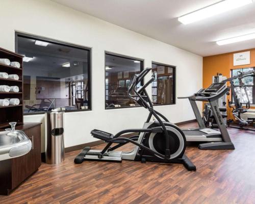 a gym with two exercise bikes in a room at Comfort Suites near NASA - Clear Lake in Webster
