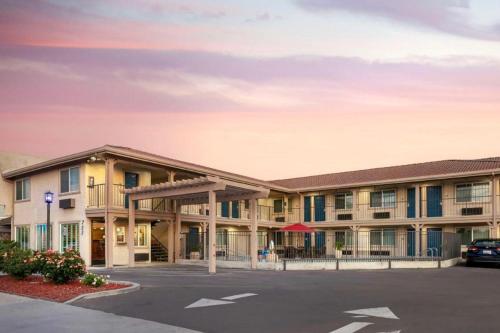 an exterior view of a building with a parking lot at Best Western Hanford Inn in Hanford