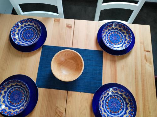 a group of blue plates on a wooden table at Da Francesca in Meduno