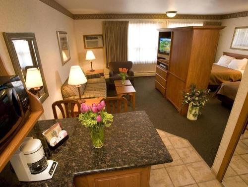 a hotel room with a living room and a hotel room at Quality Inn & Suites Detroit Lakes in Detroit Lakes