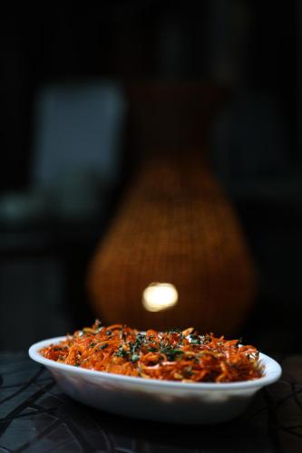 a plate of food sitting on a table at Sleeping Beauty Hotel Moutain view property in Joshīmath