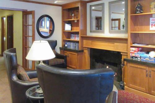 a living room with a chair and a fireplace at Quality Inn & Suites Detroit Lakes in Detroit Lakes