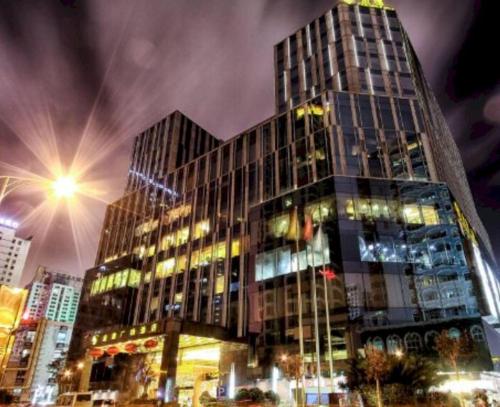 a tall building with a lot of lights on it at Kunming Golden Eagle Summit Hotel in Kunming