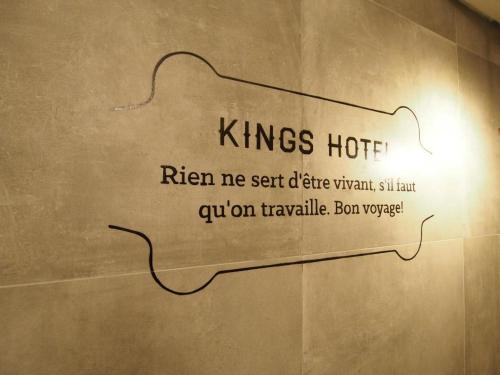 a sign on a wall in a bathroom at King's Hotel in Hong Kong