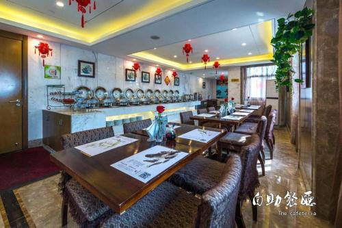 a dining room with wooden tables and chairs at Huangshan Yupinglou Hotel in Huangshan
