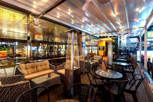 a restaurant with tables and chairs and a bar at Hotel One Byeonsan in Buan
