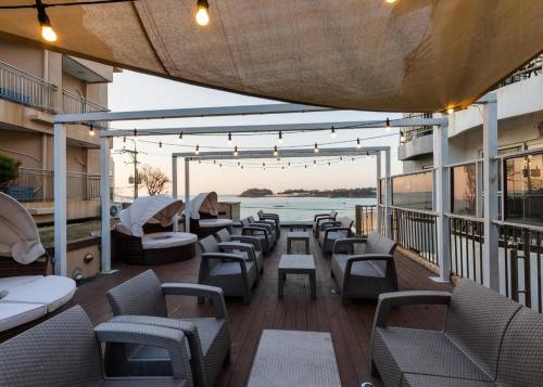 a balcony with chairs and tables on a building at Hotel One Byeonsan in Buan