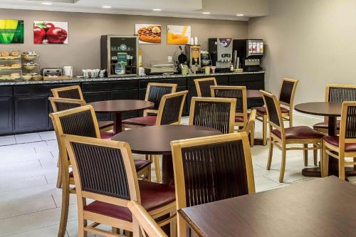 a restaurant with tables and chairs and a counter at Suburban Studios Mason Hwy 42 in Mason