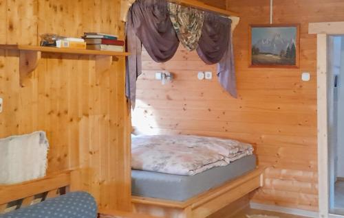 a bed in a log cabin with a window at Ferienhaus In Ruhiger Lage in Vordernberg