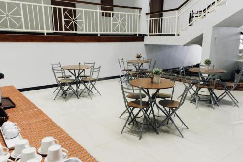 a group of tables and chairs in a room at Urban House 195 in Chiang Mai
