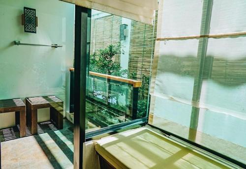 a room with a window with a fish tank in it at Phi Phi Nice Beach Hotel Hip in Phi Phi Don