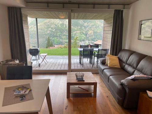 a living room with a couch and a table at Schwarzhornblick in Grächen