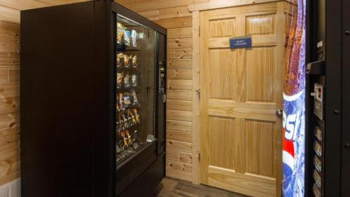 a room with a door and a drink refrigerator at Quality Inn Superior - Duluth in Superior