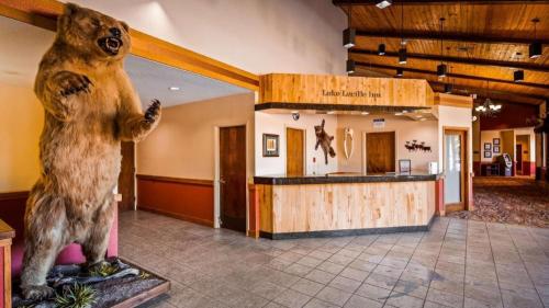 a statue of a bear standing in front of a store at Best Western Lake Lucille Inn in Wasilla