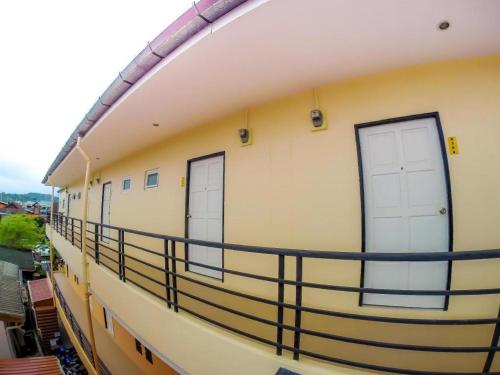 a balcony with two doors on the side of a building at My Place Phuket Airport Mansion in Patong Beach