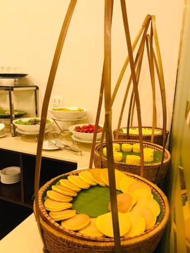 two baskets of food on a counter in a kitchen at Lenid Hotel Tho Nhuom in Hanoi