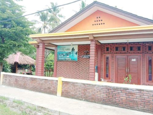 Фотография из галереи OYO 3303 Penginapan Putri Asih Sawarna в городе Sawarna