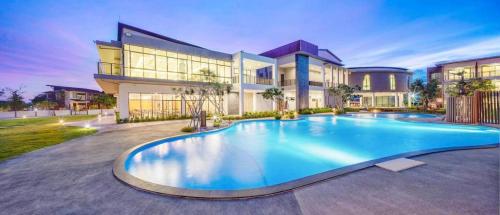 a large swimming pool in front of a house at i Tara Private in Phetchaburi