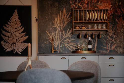 a dining room with a table and chairs and a wall at Johann und Anna am Stainzbach in Stainz