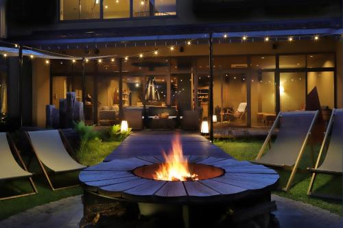 a fire pit in the middle of a patio at night at Oyado Morinone in Kaminoyama