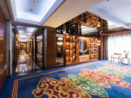 a large room with a large rug on the floor at Inner Mongolia Hotel Forbidden City in Beijing