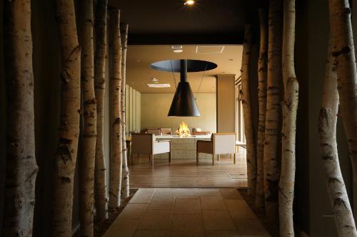 a hallway with a dining room and a table with a fire at Oyado Morinone in Kaminoyama