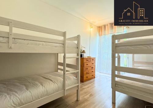 a bedroom with two bunk beds and a dresser at T3 - WELCOME - Cluses in Cluses