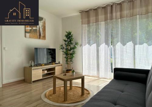 a living room with a couch and a tv at T3 - WELCOME - Cluses in Cluses