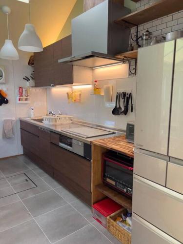 a kitchen with a sink and a stove top oven at Misato Guest House in Suita