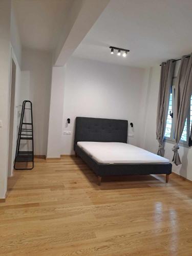 a bedroom with a bed in the middle of a room at Exarcheia House in Athens