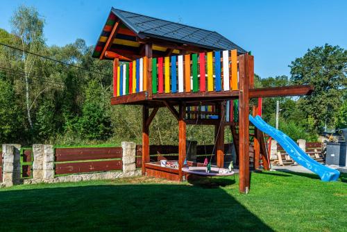 a play structure with a slide and a playground at Apartmán na okraji města s vlastním parkováním in Česká Lípa