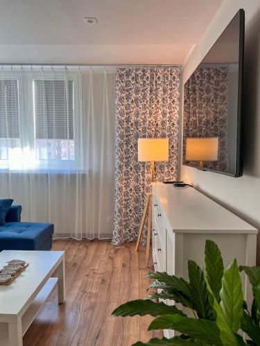 a living room with a blue couch and a table at Heron in Tychy