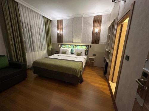 a bedroom with a large bed and a chair at The Best City Kadikoy in Istanbul