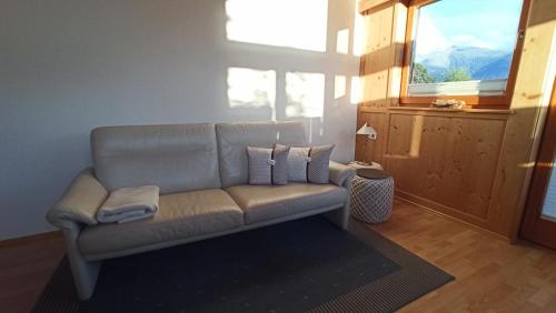 a couch sitting in a living room with a window at Apartment Guem in Obsteig