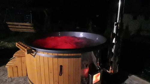 a large pot of red liquid in aperature at Aqualina Colibita - pe malul lacului in Colibiţa