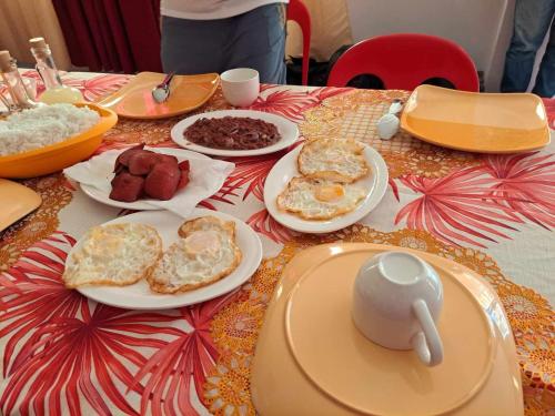 a table with plates of breakfast food on it at Estefania Homestay in Santa Monica