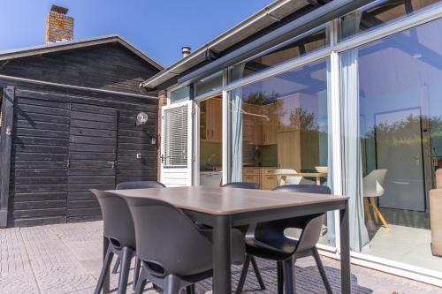 a dining room with a table and chairs at Boerenslag 24 in Sint Maartensvlotbrug