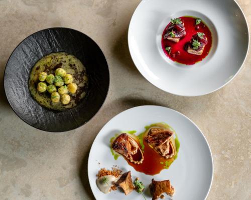three plates of food on a table at Borgo San Luigi in Monteriggioni