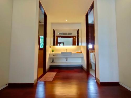 a bathroom with a sink and a large mirror at Pranaluxe 4 Bedroom Pool Villa C6 in Pran Buri
