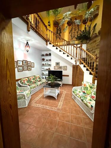 a living room with couches and a staircase at Casa Loli y Las in Agaete