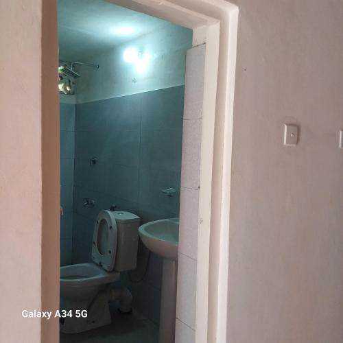 a bathroom with a toilet and a sink at Muthupalasa in Anuradhapura