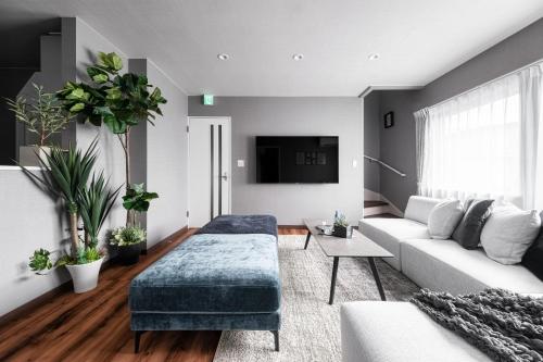 a living room with a couch and a table at The Serenity in Obihiro