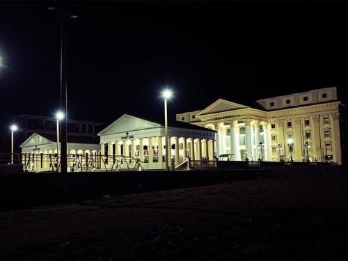 a large white building with lights at night at Vimala Regency in Ādoni