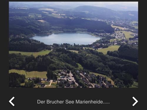 an aerial view of a lake and a city at Bruchersee-Gummersbach Nord in Marienheide