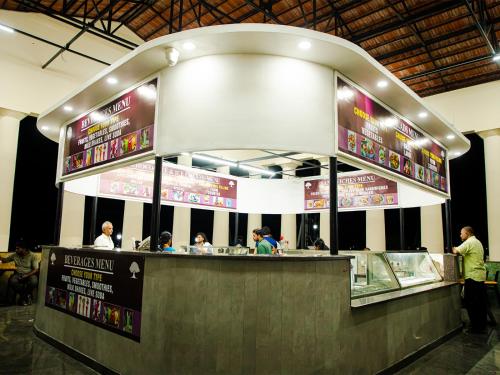 a fast food restaurant with people sitting at a counter at Vimala Regency in Ādoni