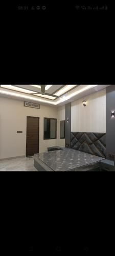 a large empty room with a table and a door at Mars Villa in Ujjain
