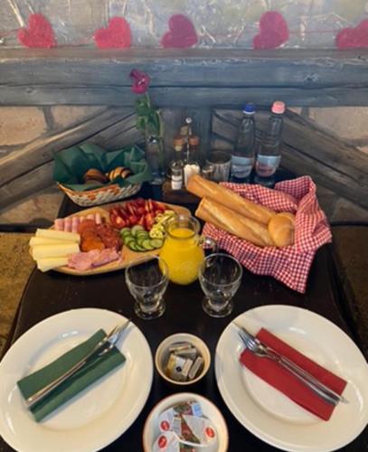 a table with plates of food on a table at Bacchus Pub és Panzió in Dunaharaszti