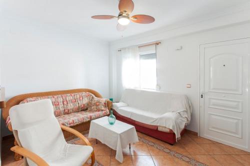 Chalet Llamàntol في أوليفا: غرفة معيشة مع أريكة وطاولة