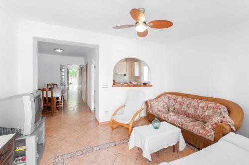 a living room with a couch and a table at Chalet Llamàntol in Oliva